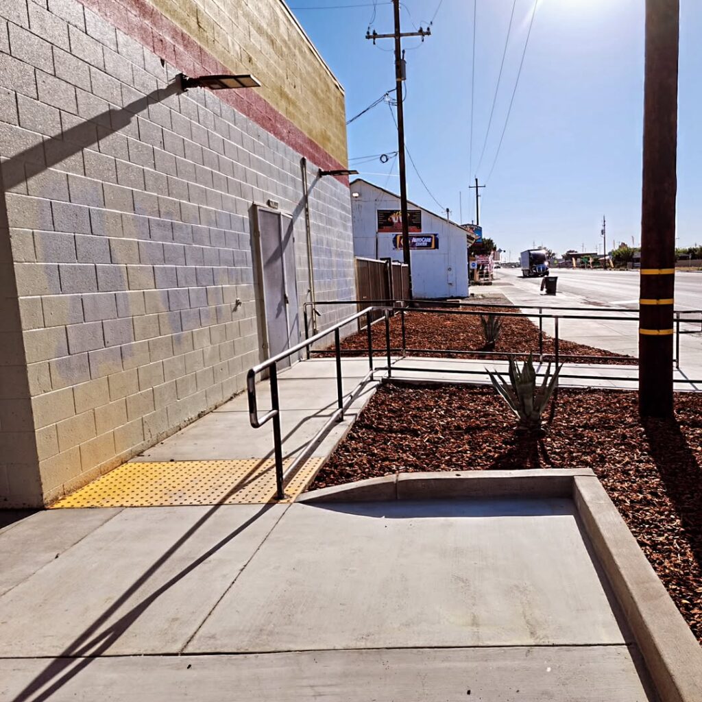 Finished handrail beside a concrete walkway