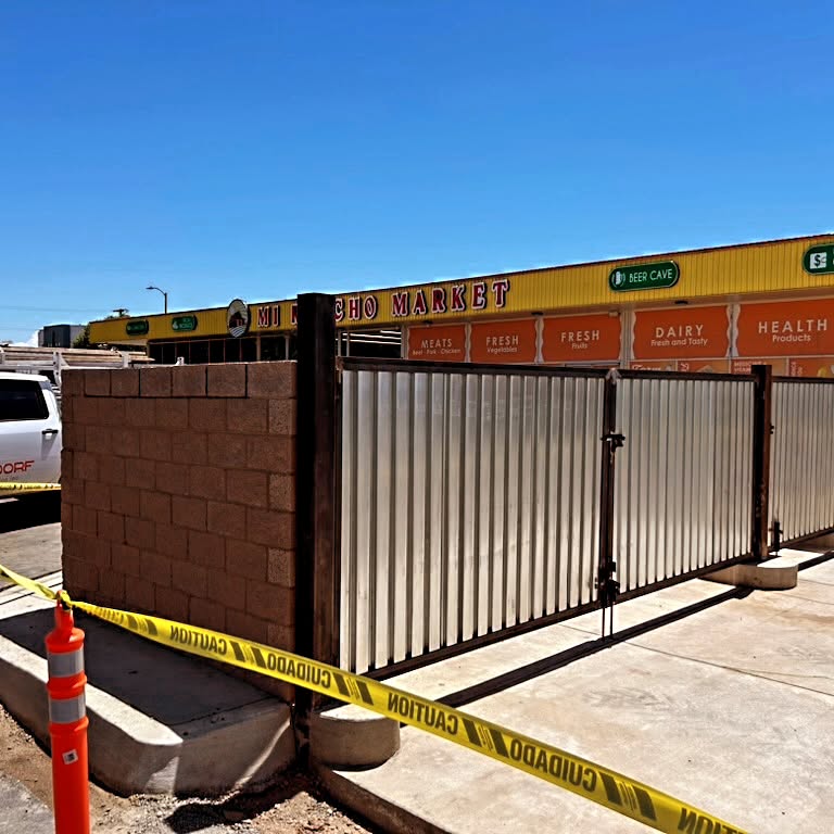 Corrugated metal fence line along a commercial lot