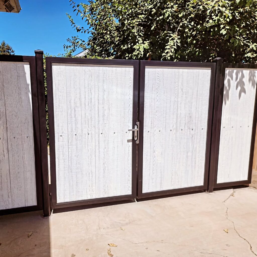 Tan panelled driveway gates with a steel frame