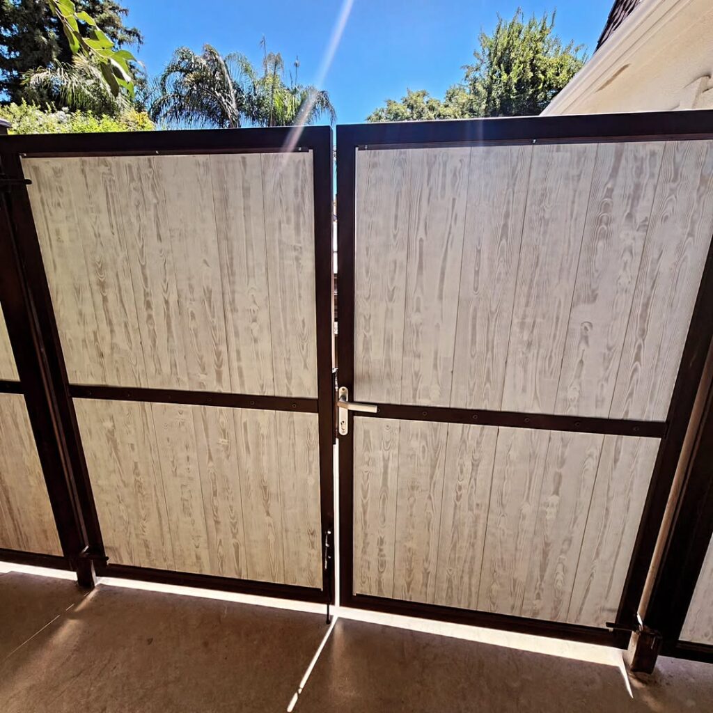 Tan panelled gate on a steel frame