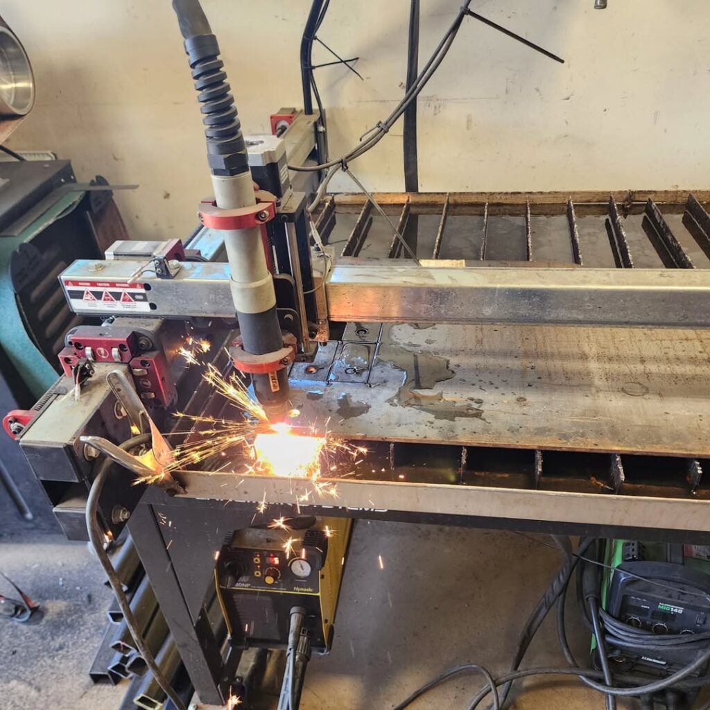 CNC plasma cutter cutting a custom metal sign