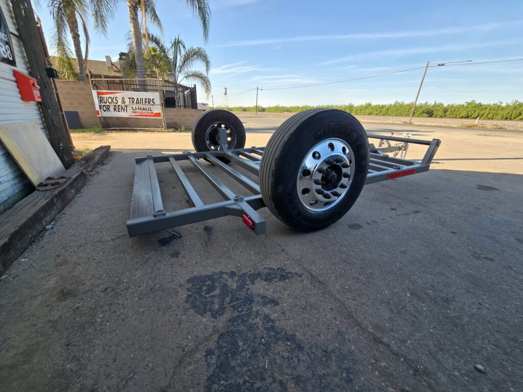 Utility trailer with a spare wheel ready for collection