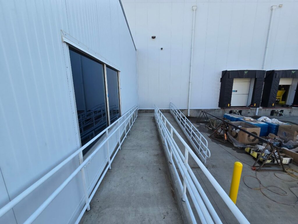 Interior ramp with a steel handrail in a commercial building