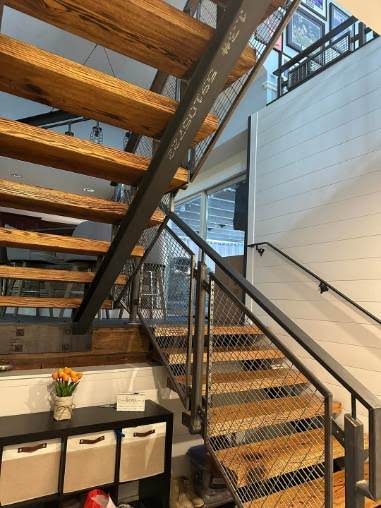 Steel staircase with timber treads and mesh railing