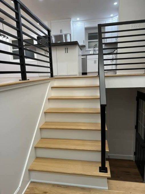 Contemporary staircase with welded black railing