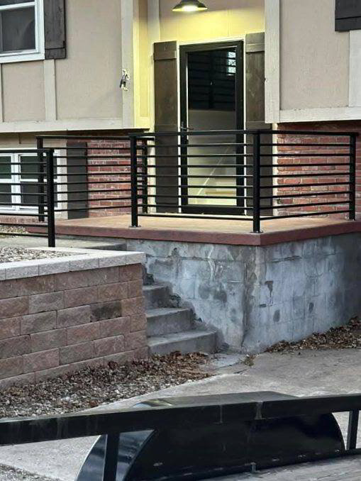 Exterior steel railing on a masonry entry